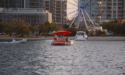 Orange Boat in front of a ferris wheel on the Broadwater Gold Coast